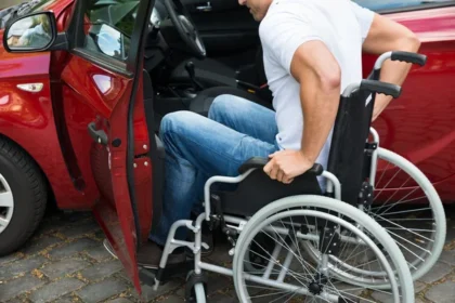 depositphotos 76114431 stock photo disabled man boarding in car